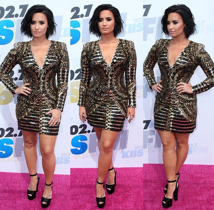 Demi-Lovato-cleavage-legs-Balmain-black-gold-dress