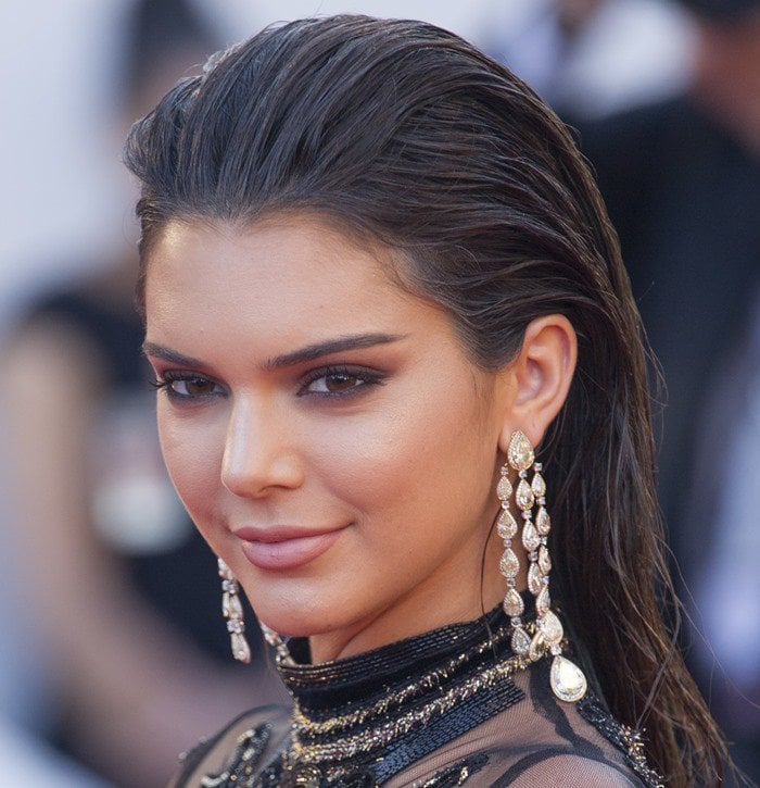 Kendall Jenner wearing statement gem-encrusted drop earrings from Chopard