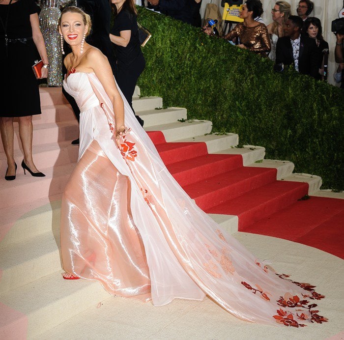 Blake Lively donned a flattering silk and chiffon Burberry gown featuring an extremely long train that extended far behind her