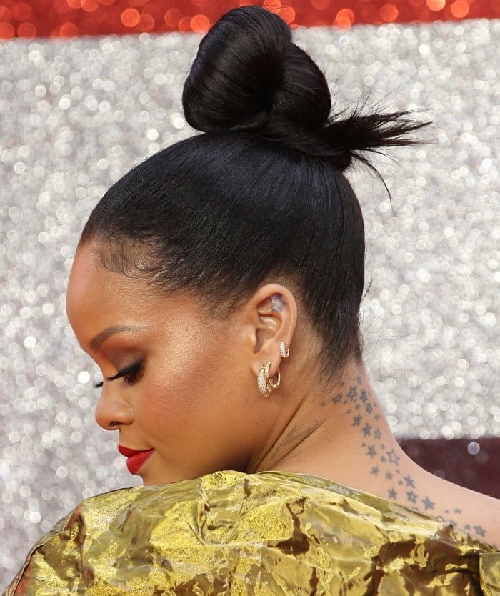 Rihanna showing off her neck and upper back star tattoos that were inked in 2008