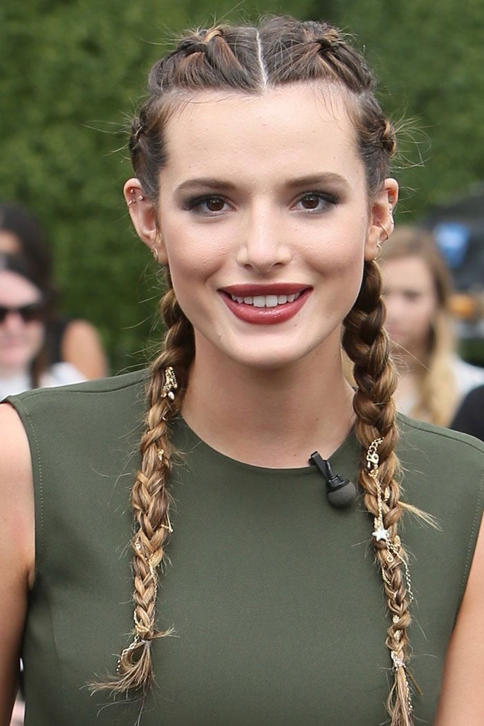 Bella gave the look some extra edge by weaving some gold jewelry through her double French braids.