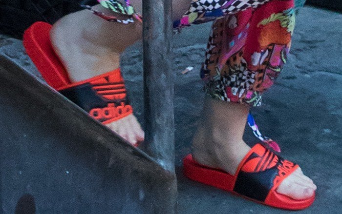 Miley Cyrus wearing red Adidas 'Adilette Trefoil' slides