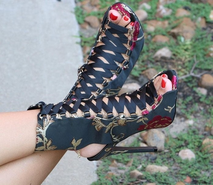 These gorgeous heels feature a satin upper with a floral brocade design throughout, peep toe silhouette, lace-up front design, and wrapped stiletto heel