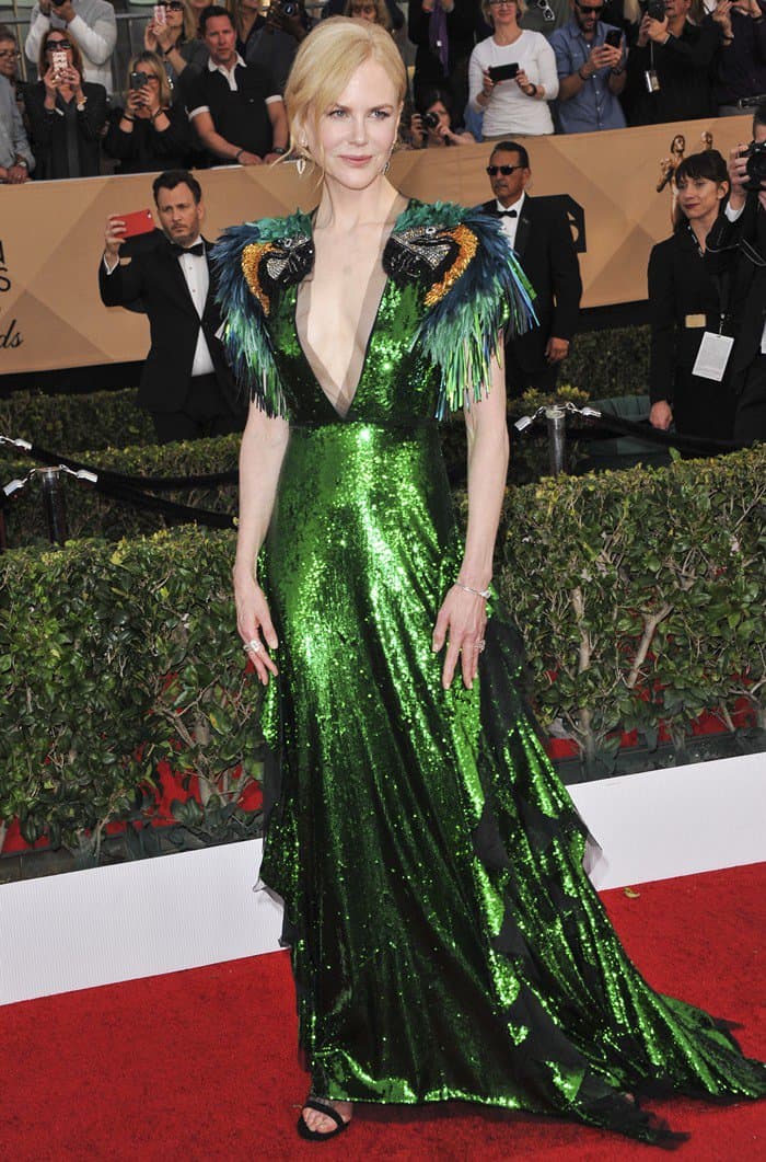 Nicole Kidman donned a playful Gucci dress featuring colorful beaded and feather parrot embroidered shoulders and a skirt with black tulle cascading ruffles