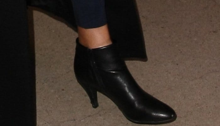 Caitlyn Jenner wearing black leather ankle boots at LAX