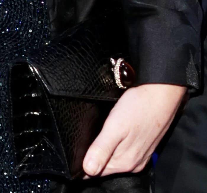 Elizabeth carries a croc-effect clutch from her go-to designer Ethan Koh