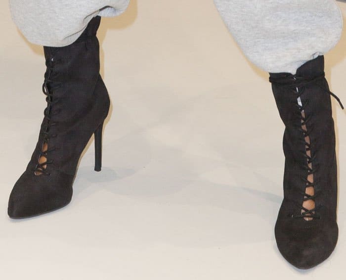 The model wears one of her ankle boots from the LonDunn + Missguided line