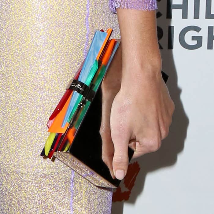 Detail of Mandy Moore's Edie Parker "Wolf Shard Lock" clutch in rainbow acrylic and silver metal.