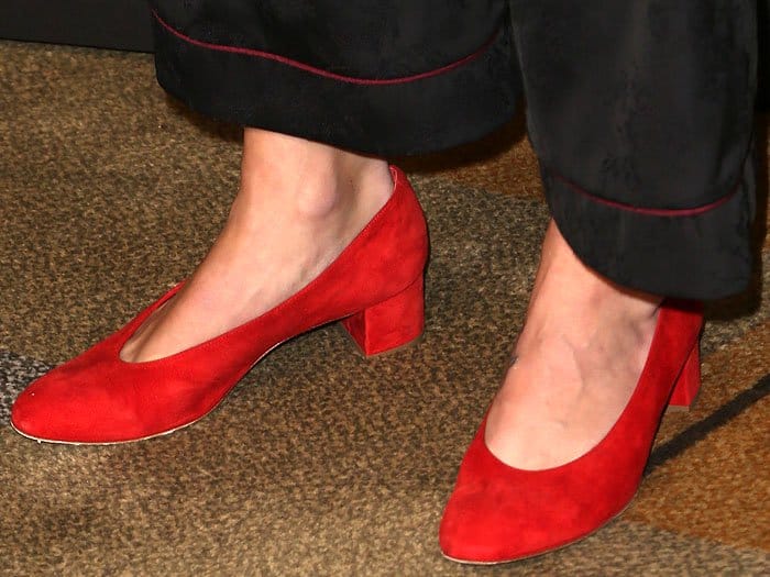 Closeup of the Mansur Gavriel red-suede ballerina pumps on Melissa Benoist.