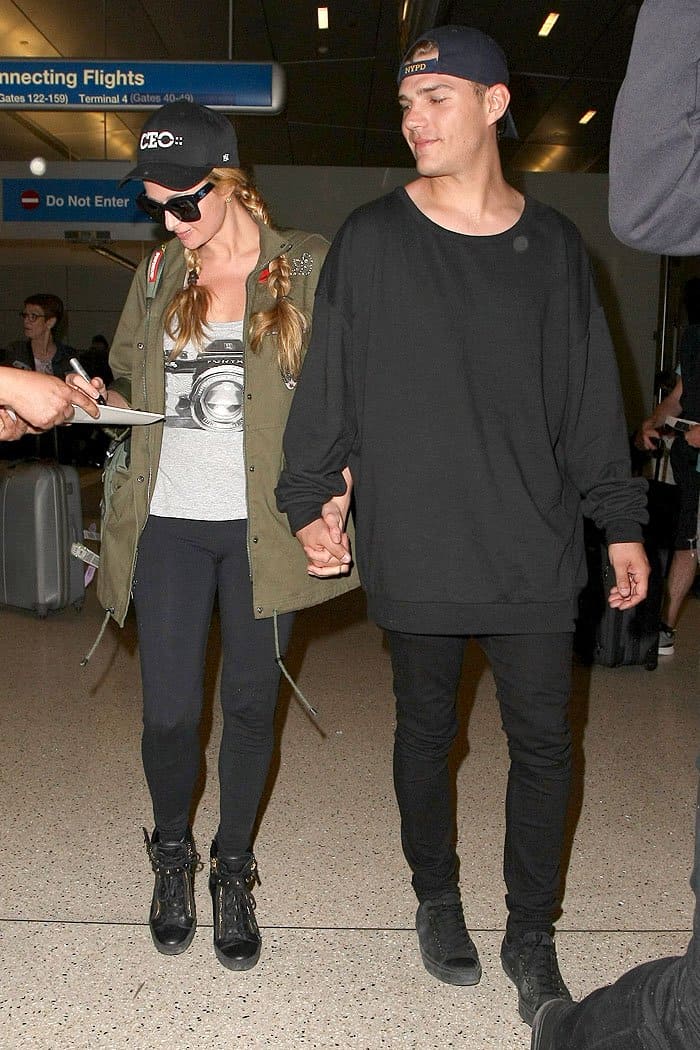 Paris Hilton holding hands with her boyfriend Chris Zylka as they arrive at the LAX airport in Los Angeles, California, on March 15, 2017.