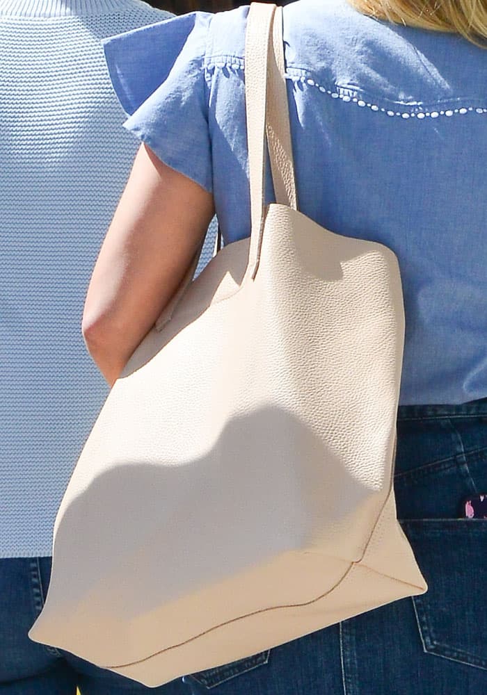 Reese switches from a bucket bag to an oversized tote