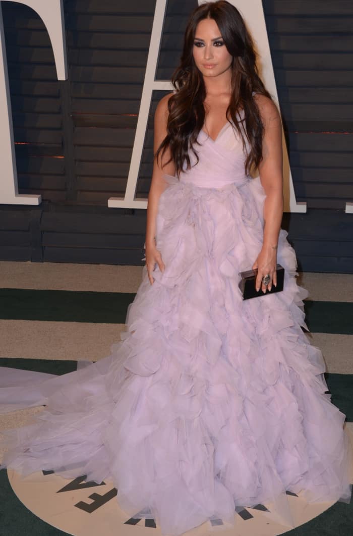 Demi Lovato wearing a lilac Monique Lhuillier gown and Giuseppe Zanotti shoes at the 2017 Vanity Fair Oscar Party