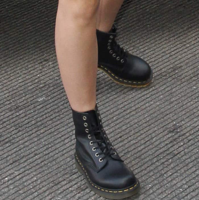 Emma Watson wearing a black leather jacket from Stella McCartney and "1460" boots from Dr. Martens at LAX