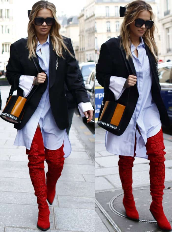 Rita Ora wearing a Vivienne Westwood oversized blazer, Jovonna London striped shirt dress, and red H&M thigh-high suede boots while out and about in Paris