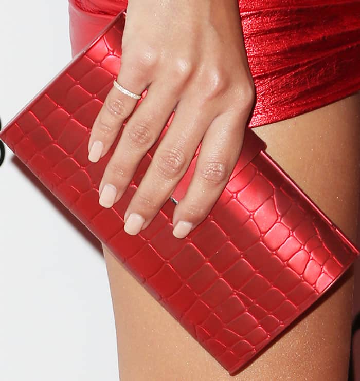 Emily added the final touch to her look with an Edie Parker embossed clutch