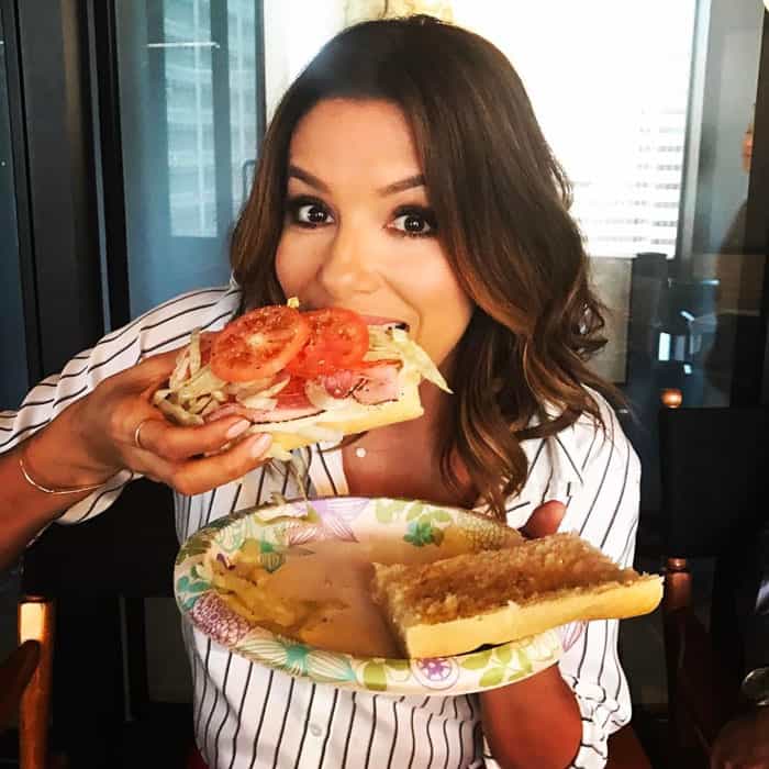 Eva digs into a scrumptious looking sandwich behind the scenes
