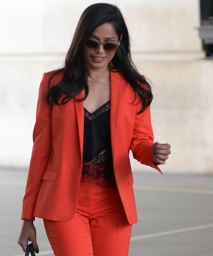 Freida Pinto wearing a red blazer and pants by Topshop styled with a black silk and lace top by Michelle Mason