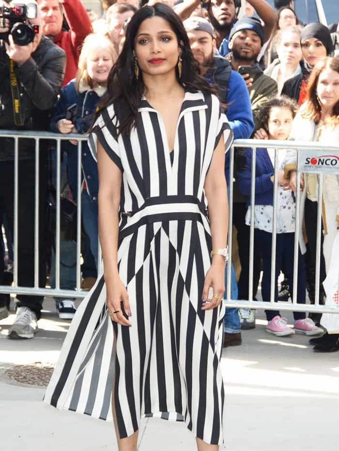 Freida Pinto wearing a black and white stripe silk crepe dress in New York City on April 3, 2017