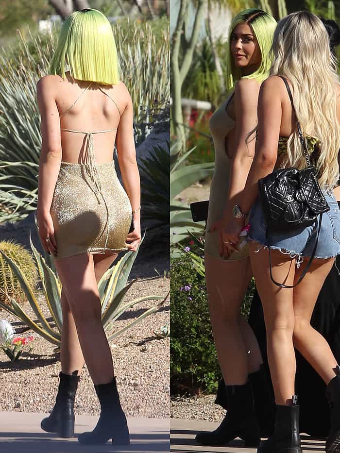 Kylie Jenner keeping her hands on her hips to stop her gold mini dress from riding up and full exposing her nude shapewear underneath.