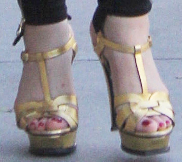 Mariah carried out her mom duties in a pair of gold Saint Laurent "Tribute" platform sandals