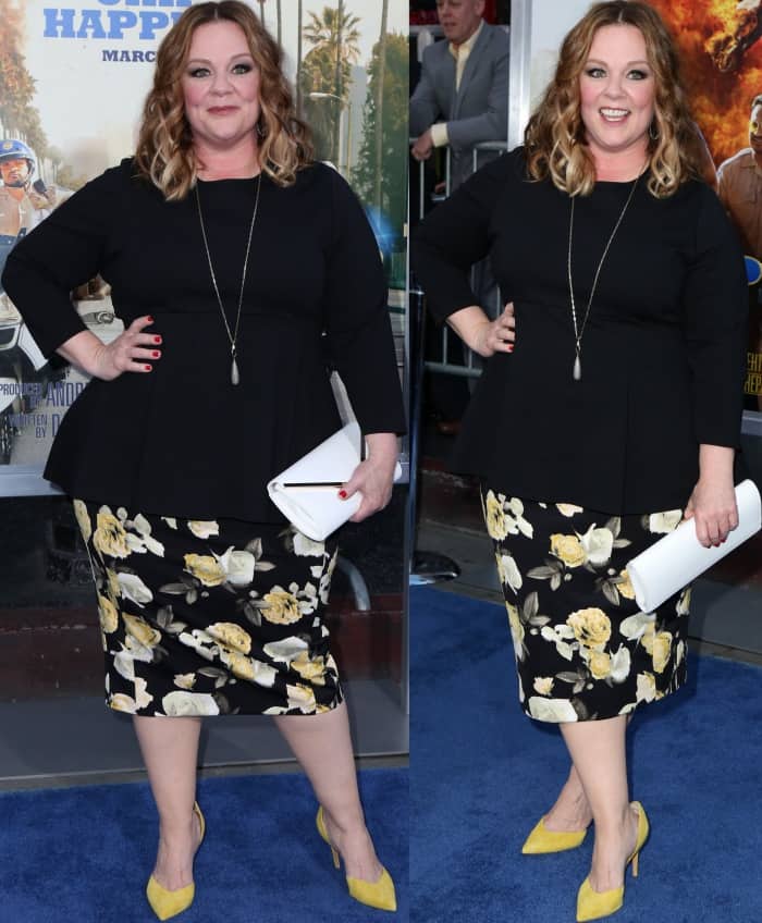 Melissa McCarthy wearing a Melissa McCarthy Seven7 flared peplum top, floral skirt, and yellow suede pumps