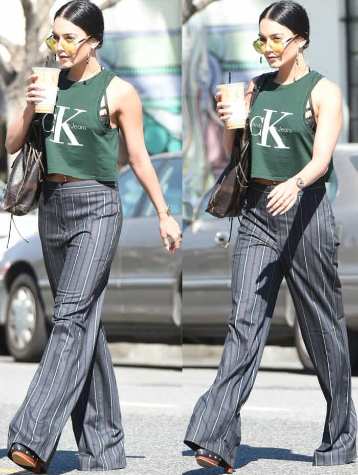 Vanessa Hudgens wearing a cropped Calvin Klein tank, striped pants, and Vince Camuto studded platform mules