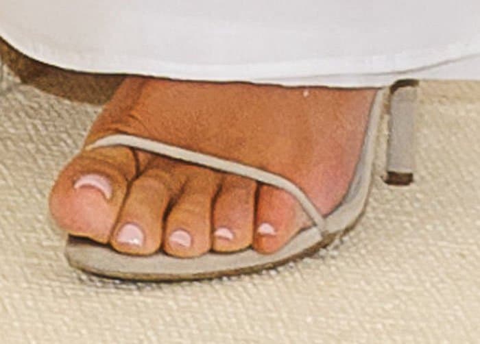 Kim allows a little bit of her Yeezy sandals to peek out