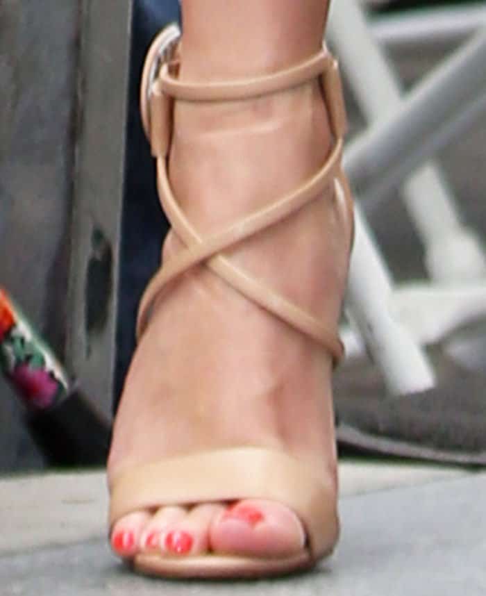 Reese toned down her look with a nude pair of nude Christian Louboutin Choca sandals