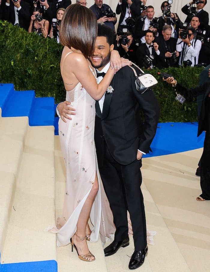 Selena Gomez showers The Weeknd with affection in a custom Coach gown for the MET Gala on May 1, 2017 at the Metropolitan Museum of Art in New York City