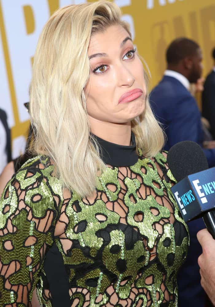 Hailey pauses to give a short interview with E! News
