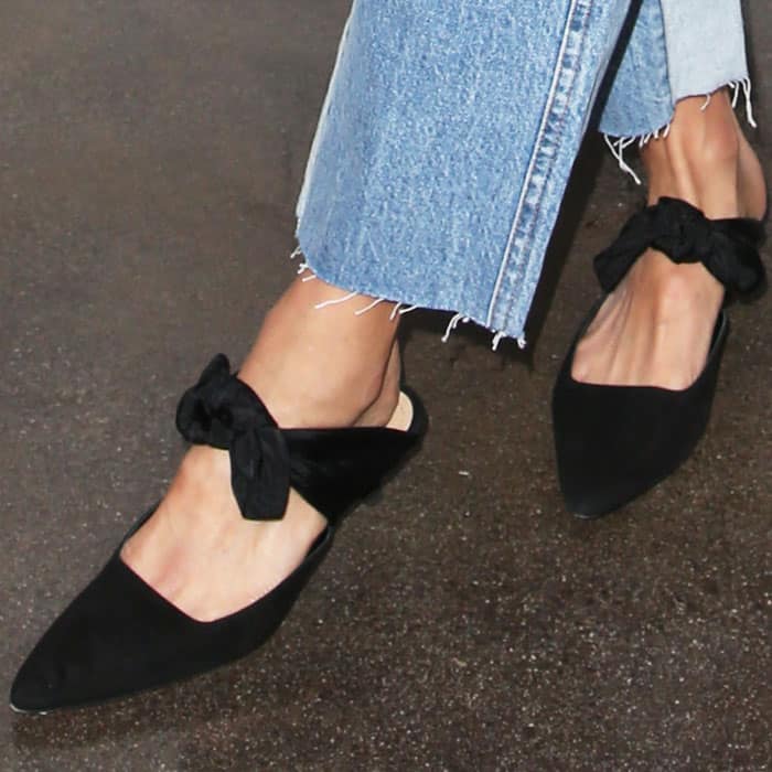 Jamie wears a pair of suede bow "Coco" mules by The Row