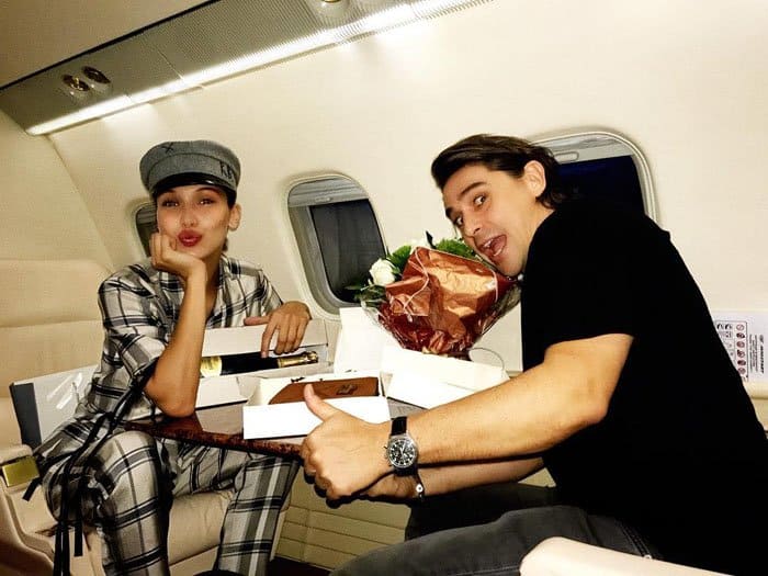 Bella wishes her Parisian manager a happy birthday as she steps into her private jet