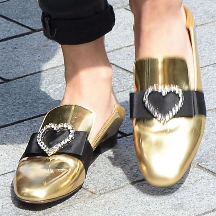 Rita puts the finishing touches on her look with a pair of Bally "Phylis" metallic leather slippers