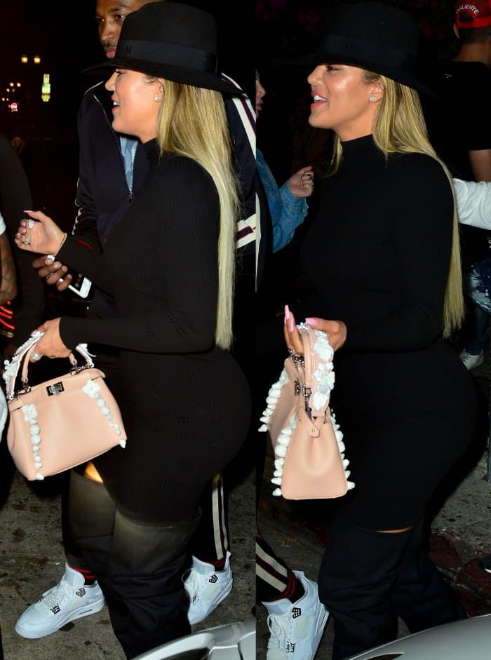Khloe Kardashian wearing a Naked Wardrobe dress, a Maison Michel fedora, and black slouchy over-the-knee boots