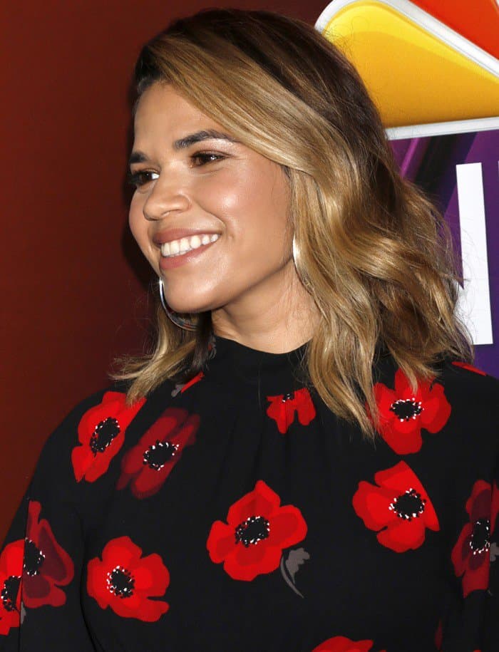 America Ferrera wearing a black and red poppy flower printed Kate Spade New York dress with flutter sleeves