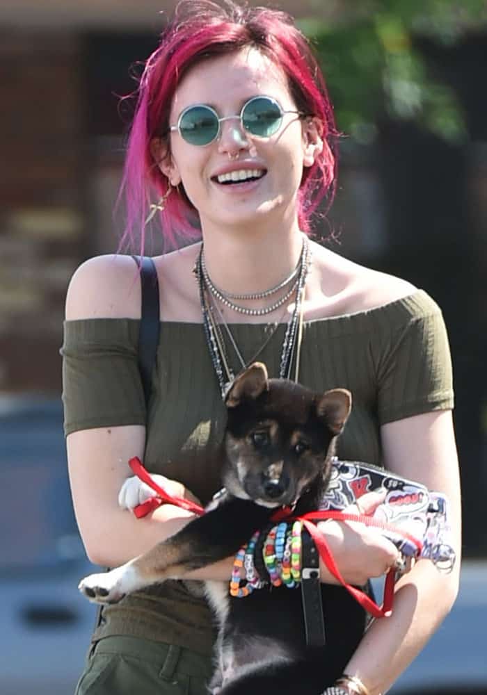 Bella Thorne cuddles her puppy as she goes to lunch in Los Angeles on August 6, 2017