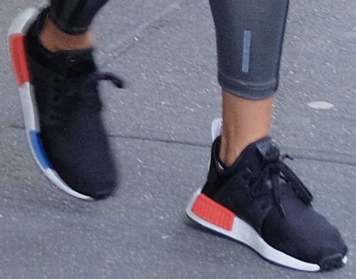 The model stayed fashionable in a pair of Adidas "NMD RX1" sneakers