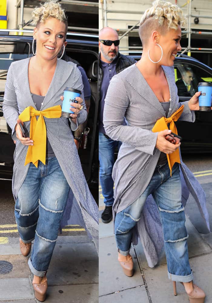 Pink was all-smiles as she emerged in London wearing a bow front jacket