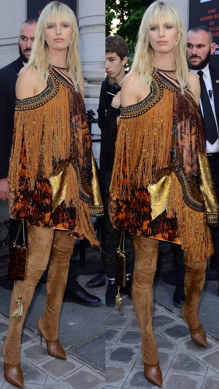Karolina Kurkova wearing a Balmain cold-shoulder dress and brown suede legging boots at the Vogue Paris Foundation dinner