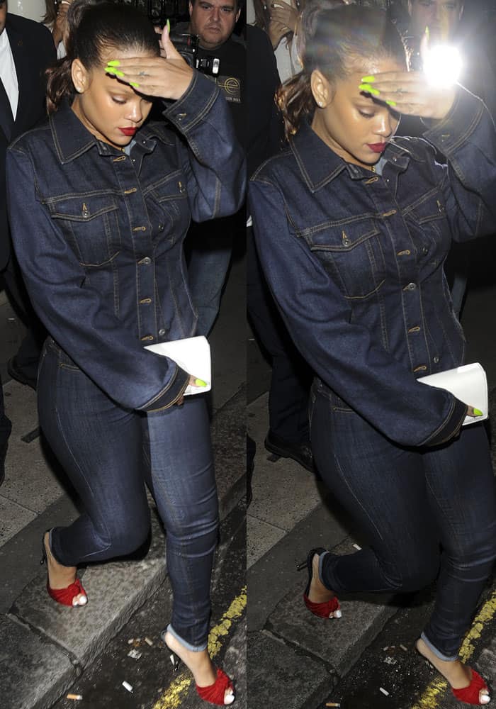 Rihanna tries to shield herself from the paparazzi