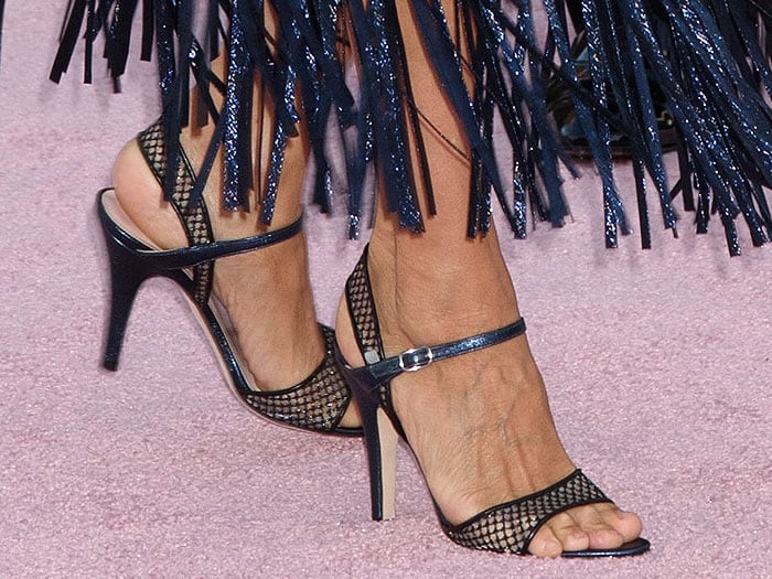Closeup of Sarah Jessica Parker's SJP Collection slingback sandals with mesh straps and blue glitter heels.