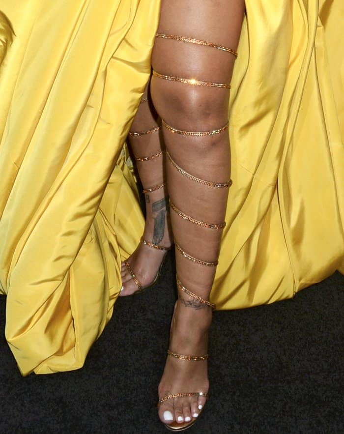 Rihanna wearing custom gold Rene Caovilla over-the-knee gladiator sandals at the Fenty Beauty by Rihanna lunch