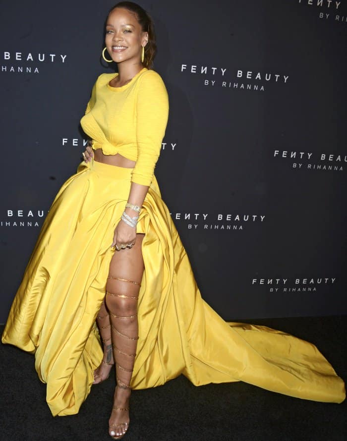Rihanna wearing a vibrant yellow Oscar de la Renta ensemble and custom Rene Caovilla over-the-knee sandals at the Fenty Beauty by Rihanna launch