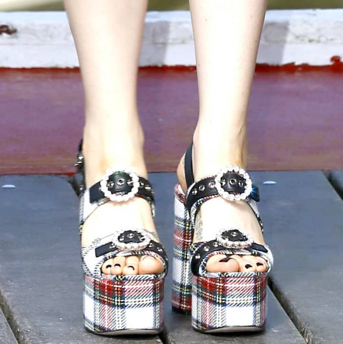 Zosia Mamet wearing Miu Miu tartan platform sandals at the 74th Venice Film Festival