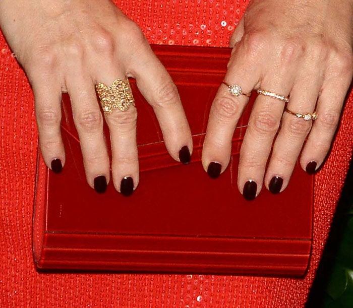 The actress goes for a deeper red with a Jimmy Choo "Candy" clutch