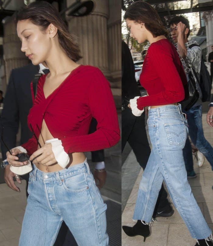 Bella Hadid wearing a red Esteban Cortazar crop top, Re/Done jeans, and Stuart Weitzman "Cling" booties while out and about in Milan