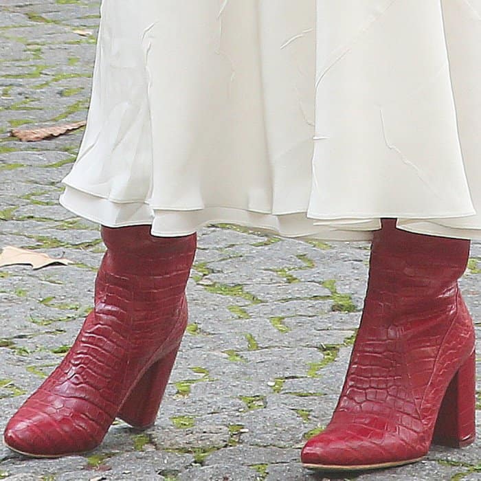 Emily Ratajkowski wearing Esquivel x Brock Collection red handstained alligator boots at the Miu Miu Spring/Summer 2018 fashion show during Paris Fashion Week