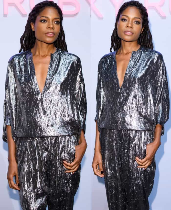 Naomie Harris wearing a Michael Kors Collection crushed silver silk-blend lamé blouse and matching tapered pants with silver pointy-toe pumps at the Michael Kors "Sexy Ruby" fragrance launch in London
