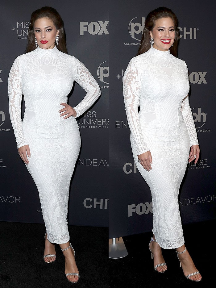 Ashley Graham put her famous curves on display in a tight, white Michael Costello embroidered-lace gown but kept things elegant with the modest high neckline and long sleeves