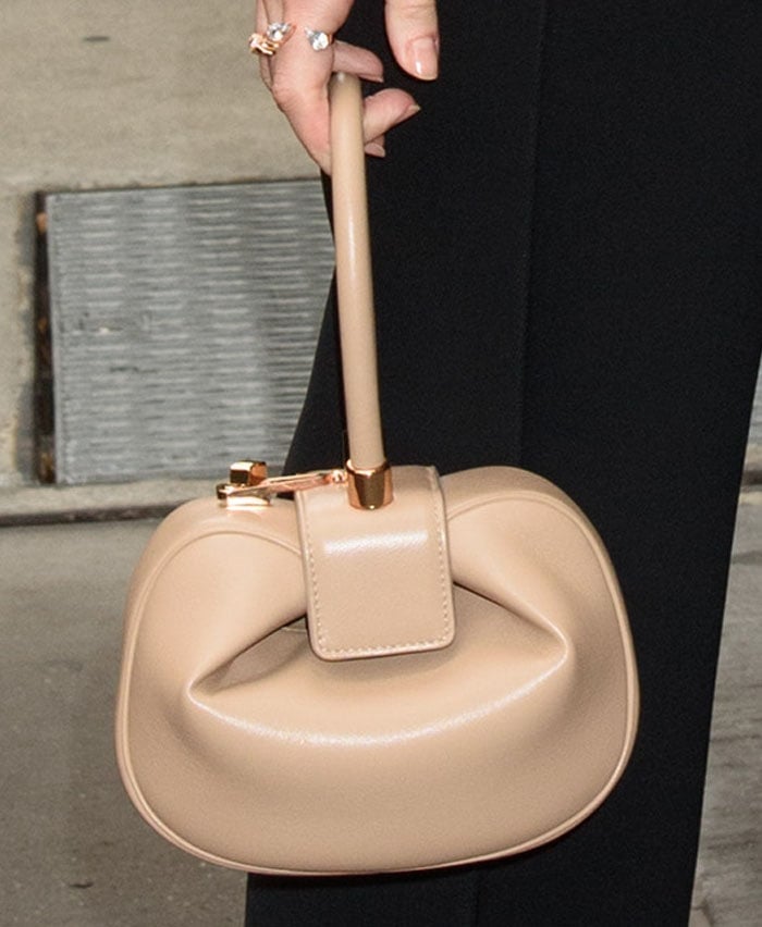 The actress keeps things neutral with a Gabriela Hearst "Demi" bag in Nude